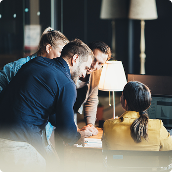 group of people discussing something around a table