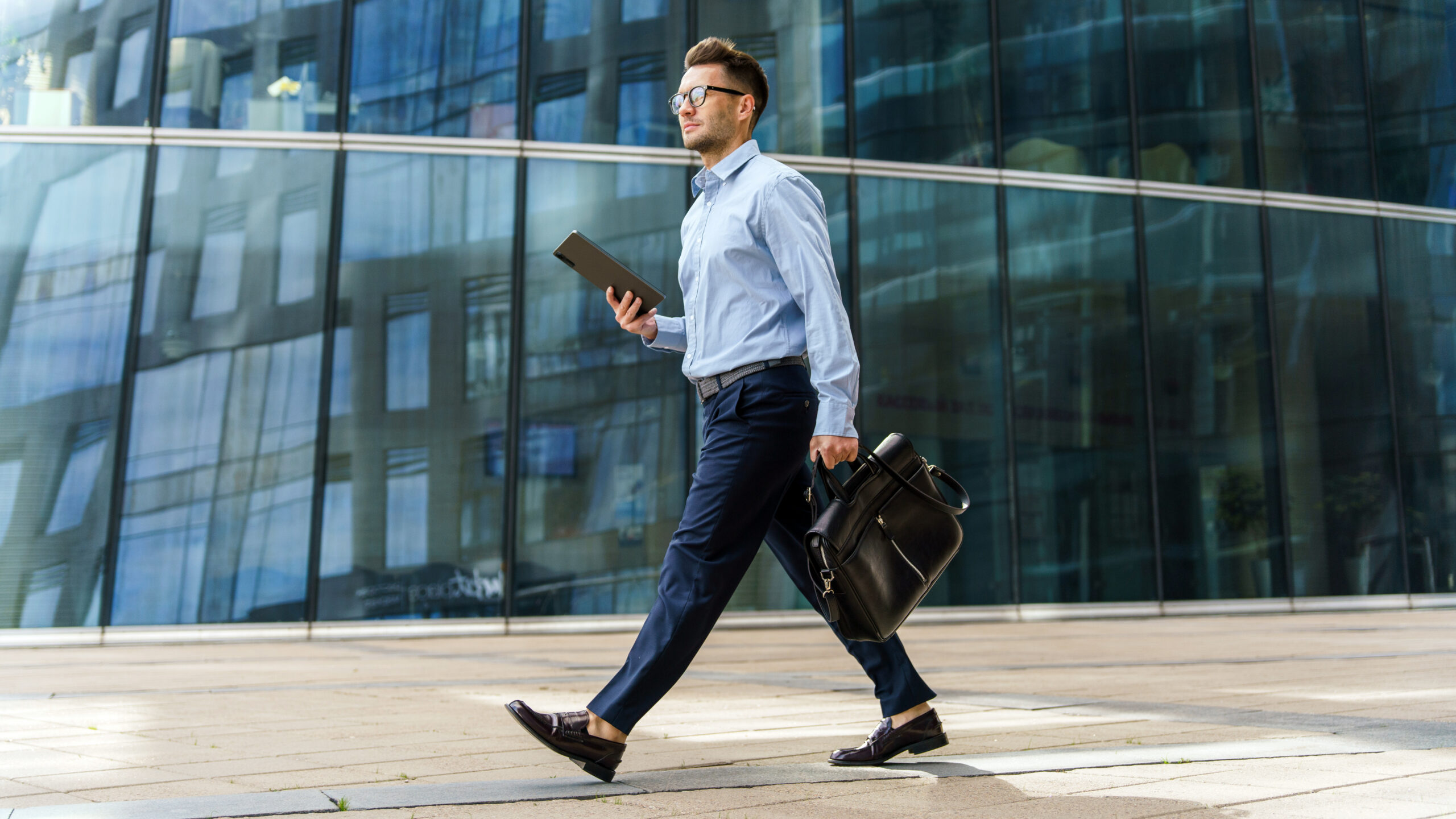 image of a man walking past a building